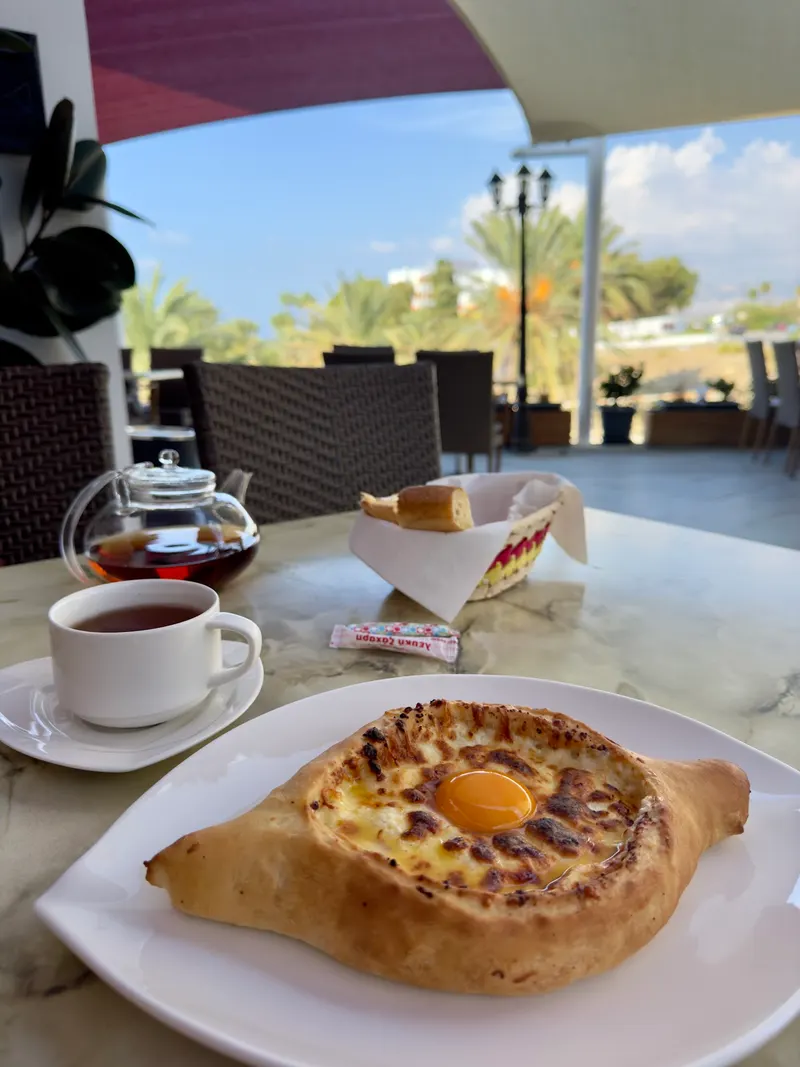 Adjaruli khachapuri with egg yolk on the terrace