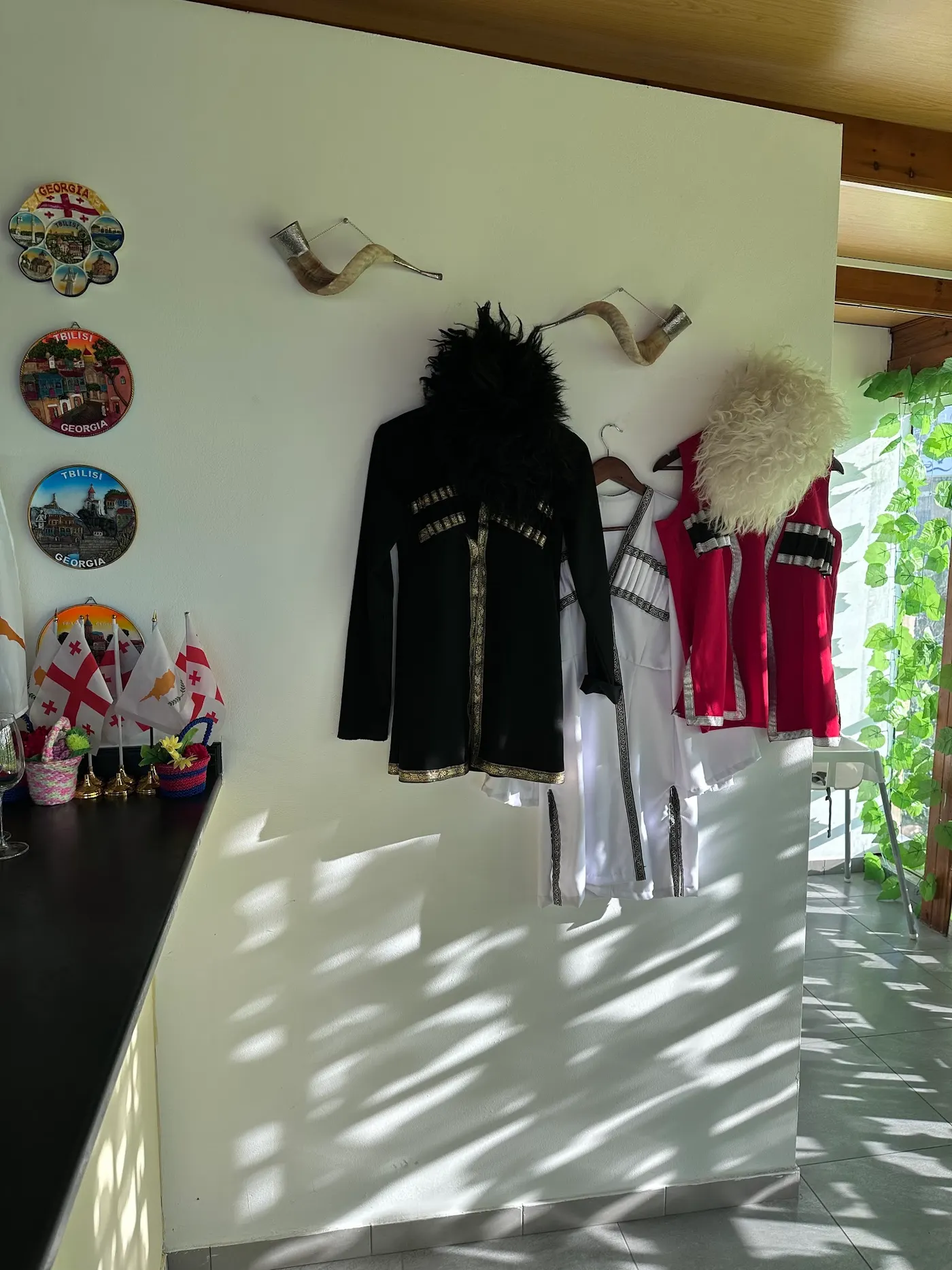 Traditional Georgian chokha costumes hanging on the wall