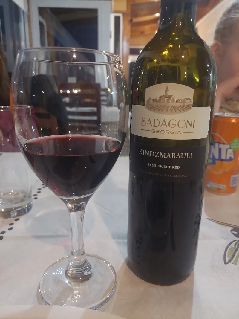 A bottle of Georgian Kindzmarauli red wine with a glass
